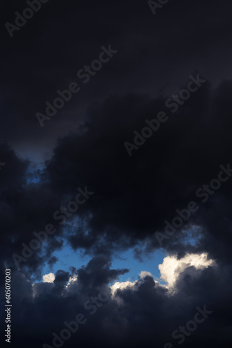 Epic Storm sky, dark grey black and white rain cumulus clouds with blue sky background texture