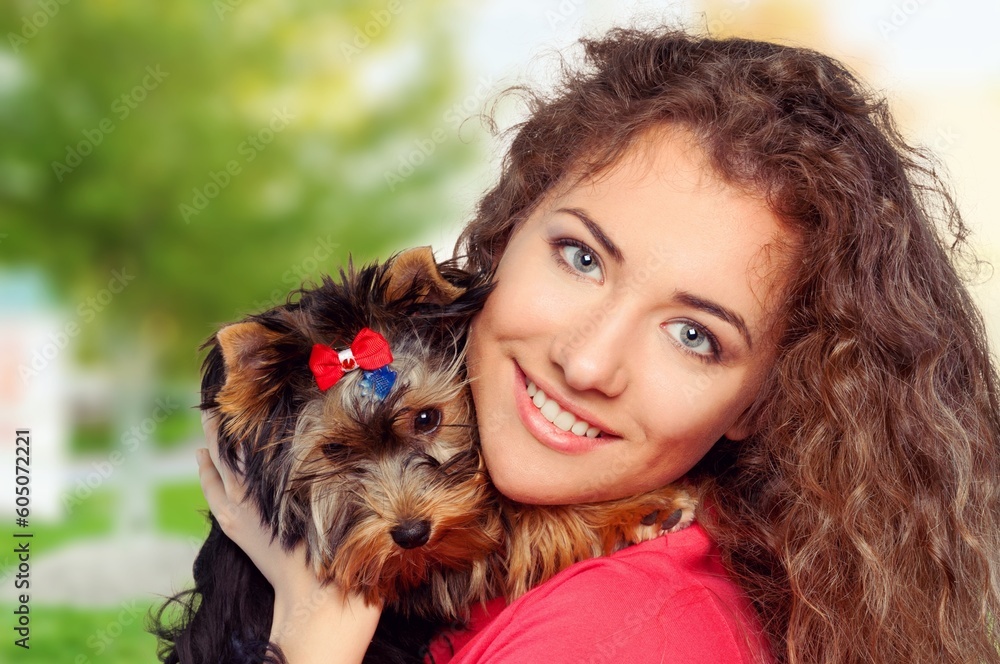 Happy young woman with cute dog in the park Happy young woman with cute dog in the park