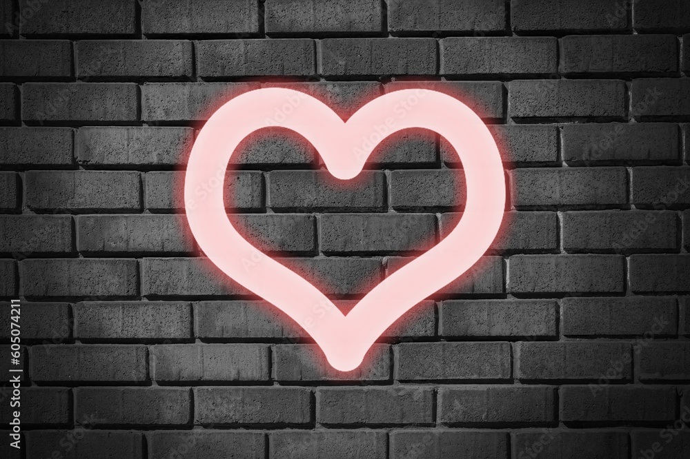 Neon red heart glow on dark wall.