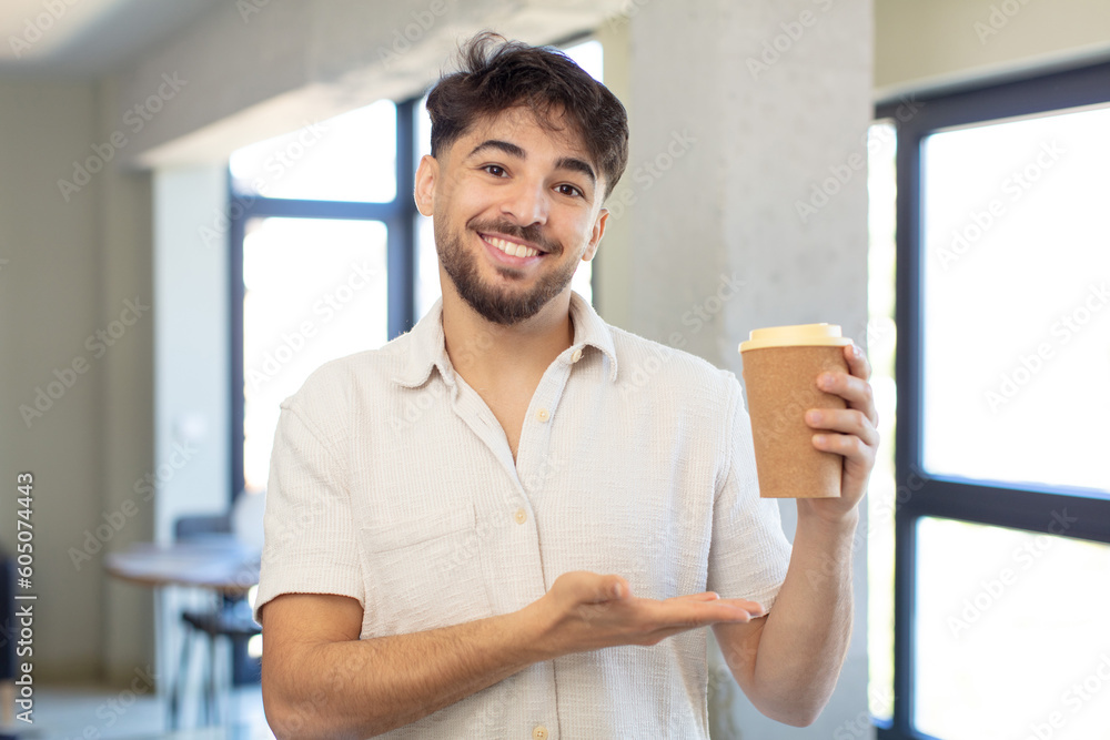 young handsome man smiling cheerfully, feeling happy and showing a concept. take away coffee concept young handsome man smiling cheerfully, feeling happy and showing a concept. take away coffee concept