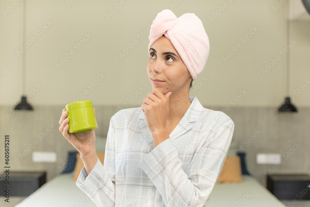 young pretty woman smiling with a happy, confident expression with hand on chin. hair product concept young pretty woman smiling with a happy, confident expression with hand on chin. hair product concept
