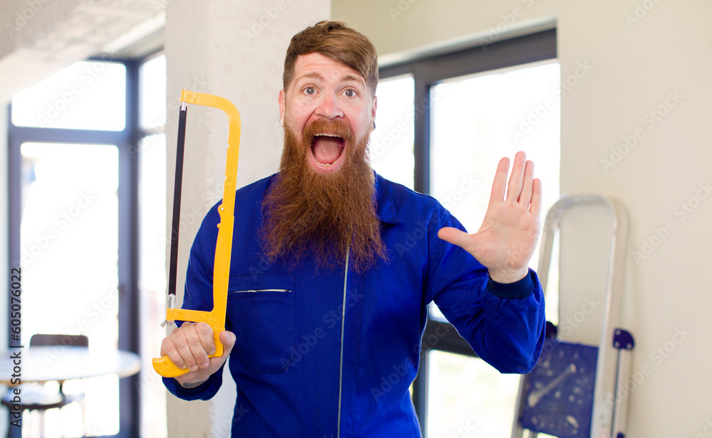 red hair man feeling happy and astonished at something unbelievable repairing home. handyman concept red hair man feeling happy and astonished at something unbelievable repairing home. handyman concept