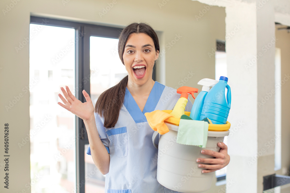 pretty young model feeling happy and astonished at something unbelievable. housekeeper concept pretty young model feeling happy and astonished at something unbelievable. housekeeper concept