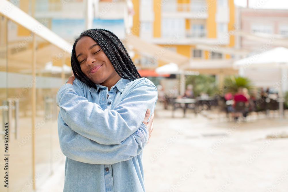 afro pretty black woman feeling in love, smiling, cuddling and hugging self, staying single, being selfish and egocentric afro pretty black woman feeling in love, smiling, cuddling and hugging self, staying single, being selfish and egocentric