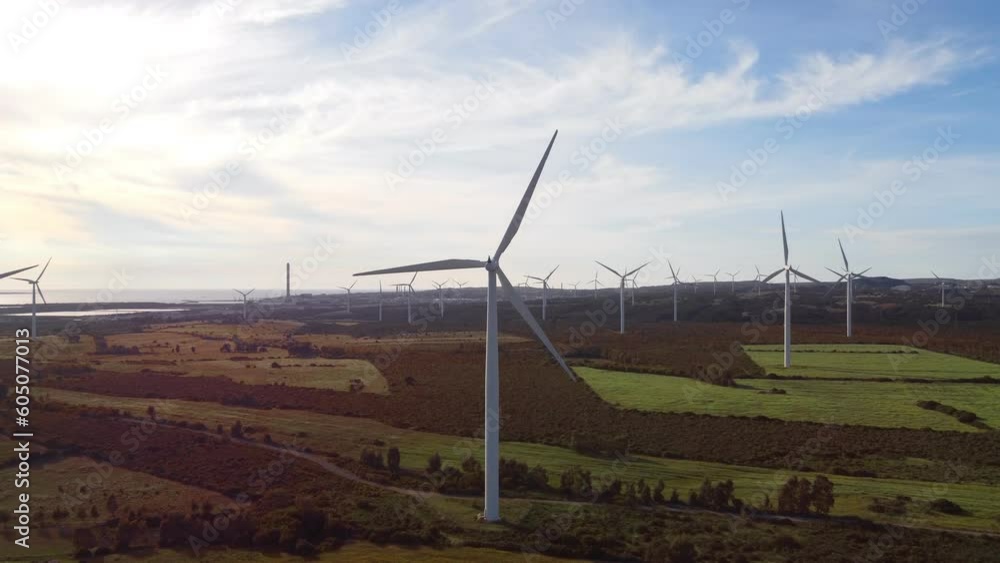Wind energy landscape, green future concept, aerial flying towards turbine Wind energy landscape, green future concept, aerial flying towards turbine
