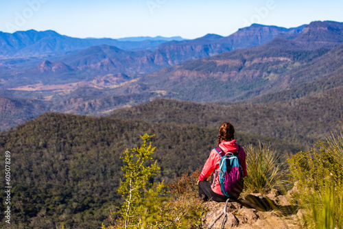 A backpacker girl enjoys the view from the top of Mount Mitchell after a successful hike, Main Range National Park, Gold, Coast, Queensland, Australia