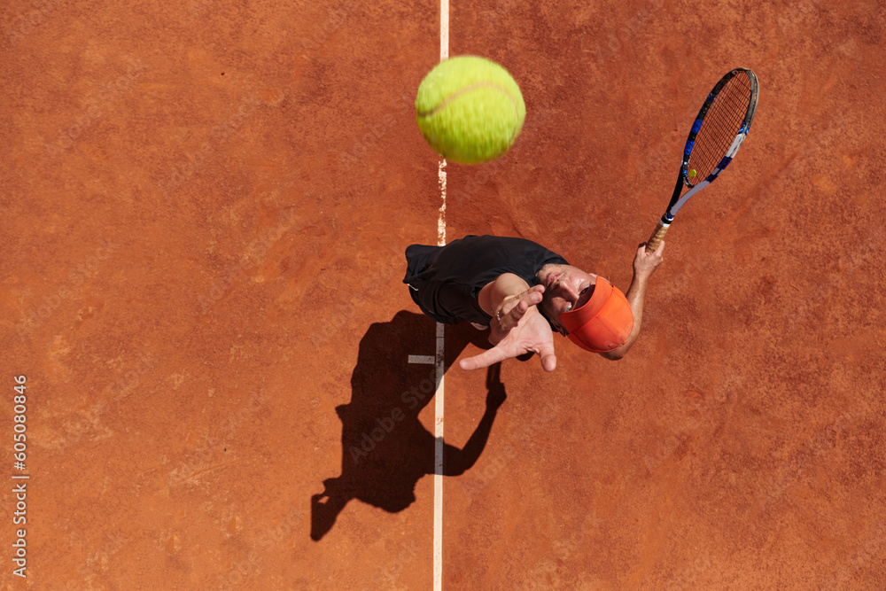 Φωτογραφία Top view of a professional tennis player serves the tennis ball on the court wit
