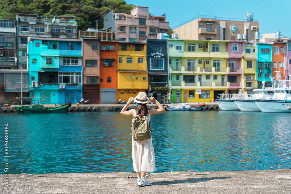 woman traveler visiting in Taiwan, Tourist with backpack and hat sightseeing in Keelung, Colorful Zhengbin Fishing Port, landmark and popular attractions near Taipei city . Asia Travel concept - obrazy, fototapety, plakaty 