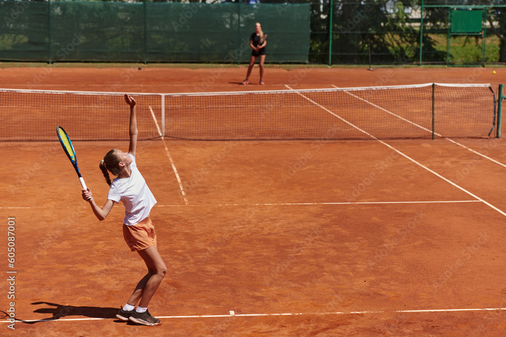Young girls in a lively tennis match on a sunny day, demonstrating their skills and enthusiasm on a modern tennis court. Young girls in a lively tennis match on a sunny day, demonstrating their skills and enthusiasm on a modern tennis court.
