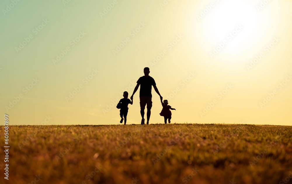 Father running with his children through an infinite and wonderful field on Father's Day - obrazy, fototapety, plakaty 