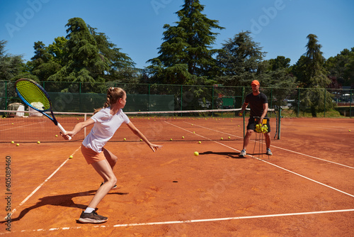 A professional tennis player and her coach training on a sunny day at the tennis court. Training and preparation of a professional tennis player