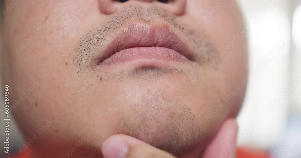 Close up Man uses hand to beard on his face. Close up Man uses hand to beard on his face.