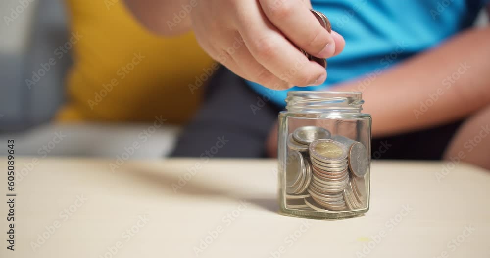 Putting coins into a jar of saving money for investment. Personal planning financial for wealth. Success strategy for the retirement fund. Putting coins into a jar of saving money for investment. Personal planning financial for wealth. Success strategy for the retirement fund.
