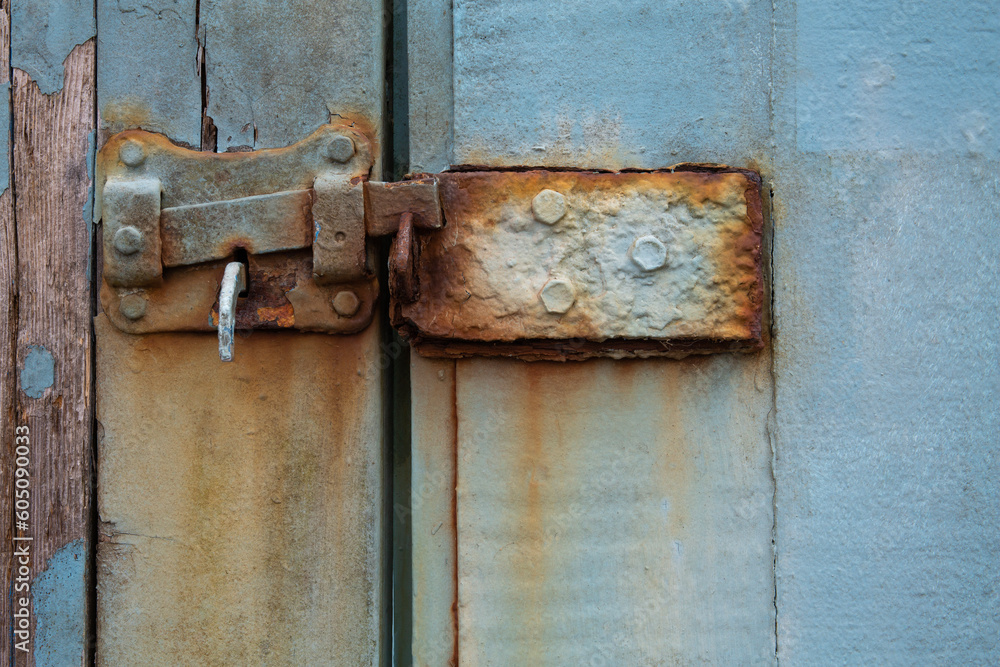 Closeup of weathered, rusty, old latch on blue wooden door
Closeup of weathered, rusty, old latch on blue wooden door