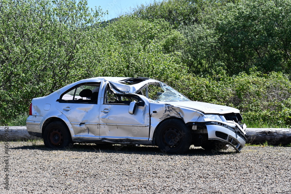 car wreck abandoned in gravel lot