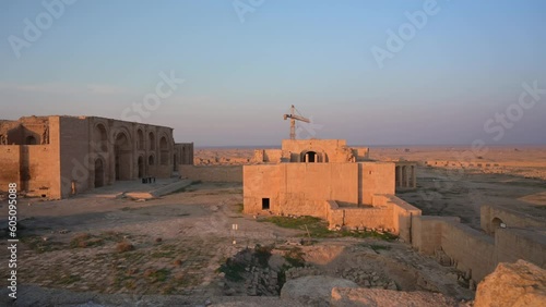 Hatra ruins in middle of desert with crane and sky in background at sunset, Iraq. FPV photo