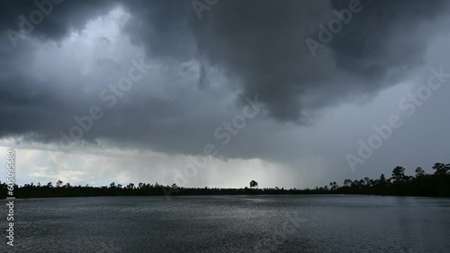 Time lapse of storm clouds forming in unsettled atmosphere above Pine Glades Lake in Everglades National Park, Florida 4K.