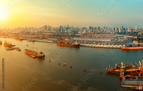 high angle view of chaopraya river and shipping dock against city scape of bangkok skyscraper photo
