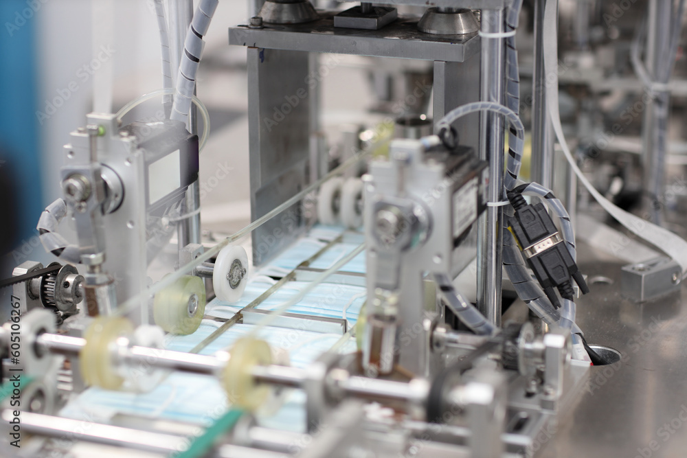 Industry and factory concept, medical face mask production line. Industry and factory concept, medical face mask production line.