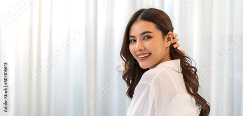 Portrait of smiling cheerful beautiful pretty asian woman clean fresh healthy white skin posing smile in in warm knitted clothes.Girl felling relax and enjoy time on the bed at home.asia beauty