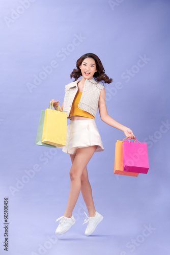 happy beautiful shopaholic asian woman carry shopping bags