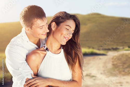Happy young couple hug on outdoor background