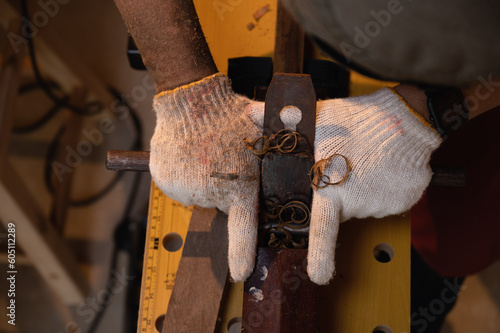 Close-up the hand of carpenter working hard while planing on wood with a manual wood planer or plane tool in workshop or carpentry workplace, Craftsman, Handyman concept.