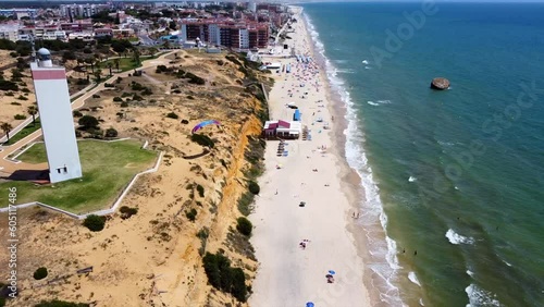 Matalascanas Town with paraglider in foreground - Drone shot photo