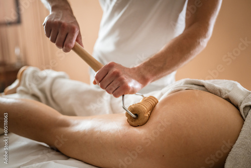 Caucasian woman having madero therapy massage anti-cellulite treatment