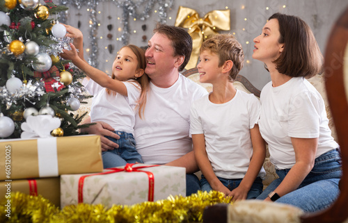 Portrait of parents with son and daughter during christmas celebration at home