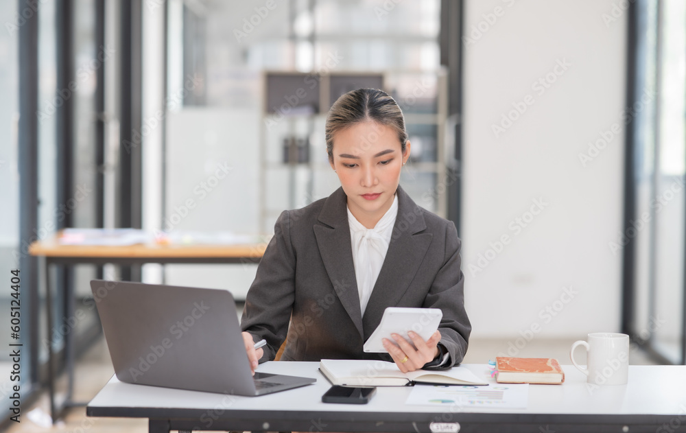 Young Asian businesswoman working on documents at office Young Asian businesswoman working on documents at office