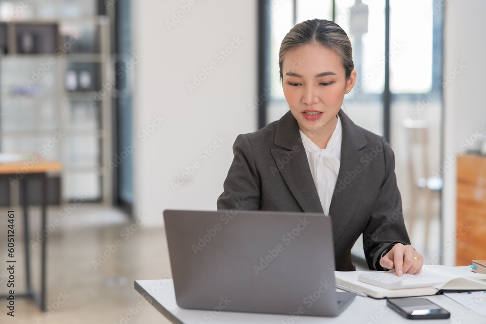 Young Asian businesswoman working on documents at office