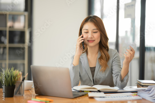 Asian businesswoman holding notebook about business, spending money