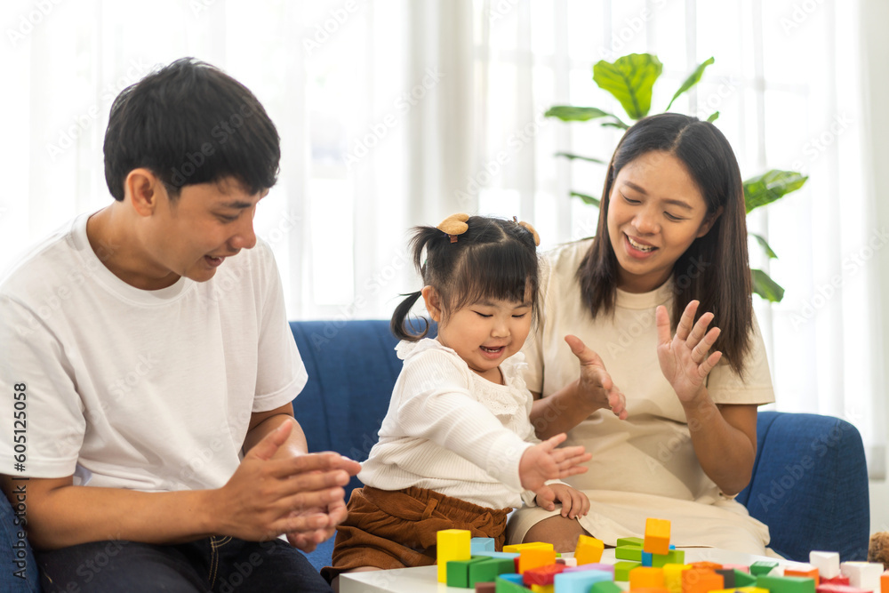 Portrait of enjoy happy love asian family father and mother with little asian girl smiling activity learn and skill brain play toy build wooden block board education game, children development at home Portrait of enjoy happy love asian family father and mother with little asian girl smiling activity learn and skill brain play toy build wooden block board education game, children development at home