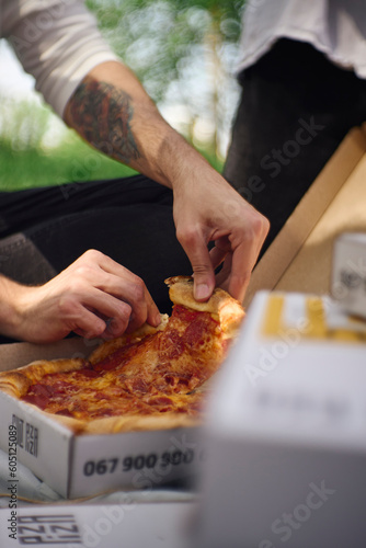 person holding pizza in a box