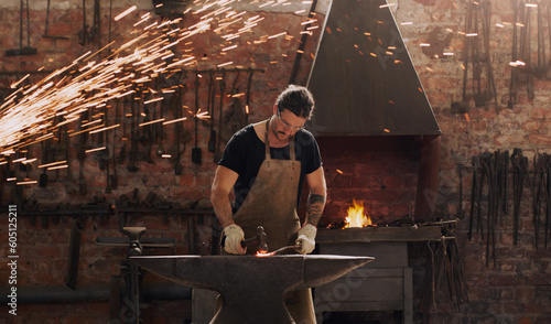 Cuadro en lienzo Hammer, anvil and fire with a man working in a plant for metal work manufacturing or production