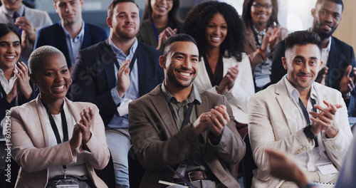 Business people, conference and audience clapping hands at a seminar, workshop or training. Diversity men and women crowd applause at conference or convention for corporate success, bonus or growth