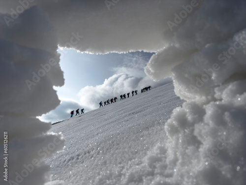 watching crowded group of mountaineers trek from the snowhole landscape photo