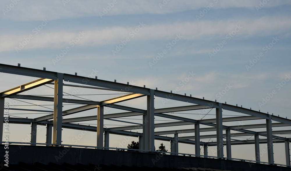 Naklejka premium Hot-rolled steel with guaranteed weldability in stock grades. Dividing to the required length is done with a saw or autogenous. construction of industrial company buildings