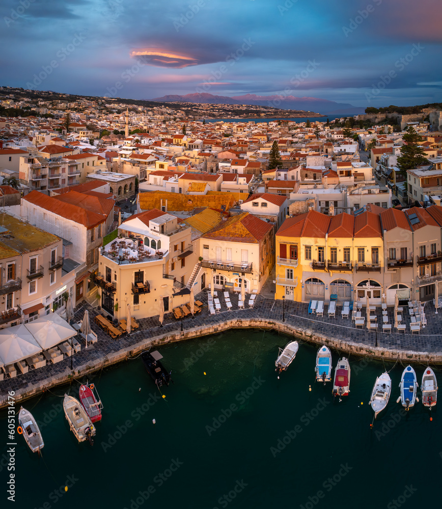 Greece's enchanting Rethymno: A mesmerizing sunrise over the old harbor and town of Rethymno in Crete, casting a golden glow on ancient Greek beauty