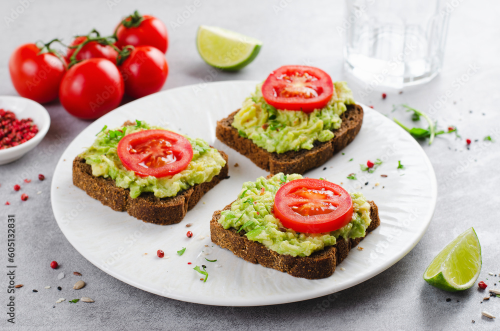 Avocado Toasts with Tomato, Healthy Snack or Breakfast on Bright Background Avocado Toasts with Tomato, Healthy Snack or Breakfast on Bright Background