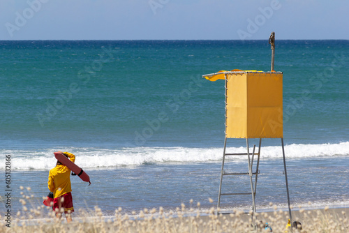 Lifeguard watching sea beach by lifeguard tower