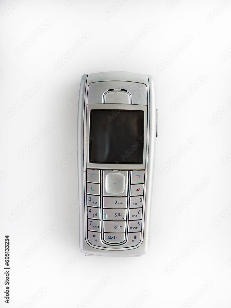 Old mobile phone isolated on white background, early wireless digital technology, communication device Old mobile phone isolated on white background, early wireless digital technology, communication device