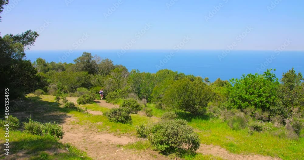 Distance View Of A Woman Walking In The Philosophical Park Of Capri Island In Campania, Italy. Wide Shot Distance View Of A Woman Walking In The Philosophical Park Of Capri Island In Campania, Italy. Wide Shot