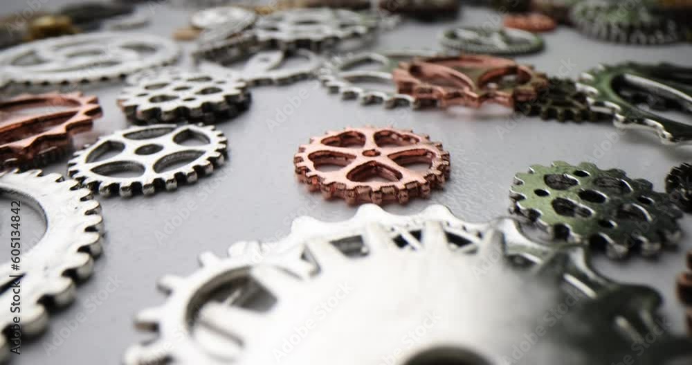 Pile of various sizes of metal gears closeup. Resource concept for business and new startup Pile of various sizes of metal gears closeup. Resource concept for business and new startup