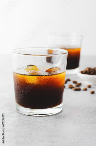 Iced Coffee, Cold Brew Coffee with Ice on Bright Background, Coffee Cocktail, Refreshing Beverage