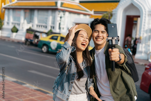 Photography Portrait of Asian man and woman couple travelers in relationship taking a selfie