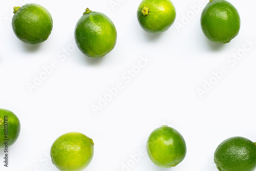 Frame made of fresh limes isolated on white background. Top view