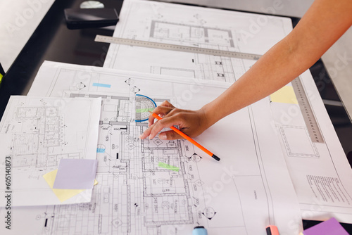Close up of hand of african american businesswoman drawing architectural plans at office, unaltered