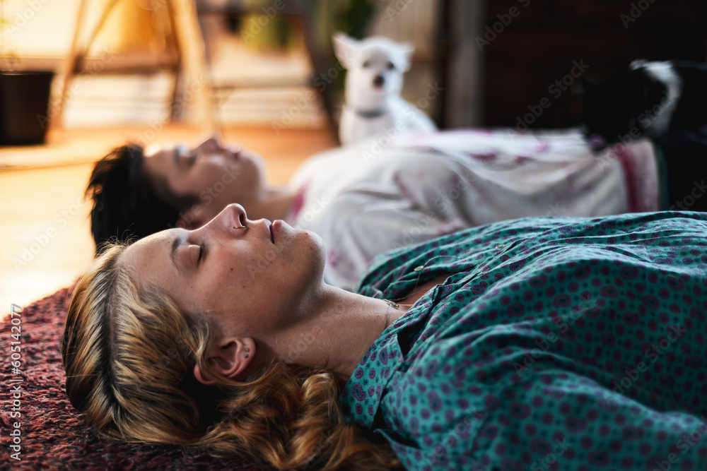 portrait of couple relaxing in meditation at home on floor portrait of couple relaxing in meditation at home on floor